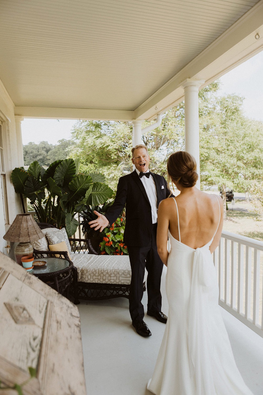 bride has first look with dad on farmhouse porch