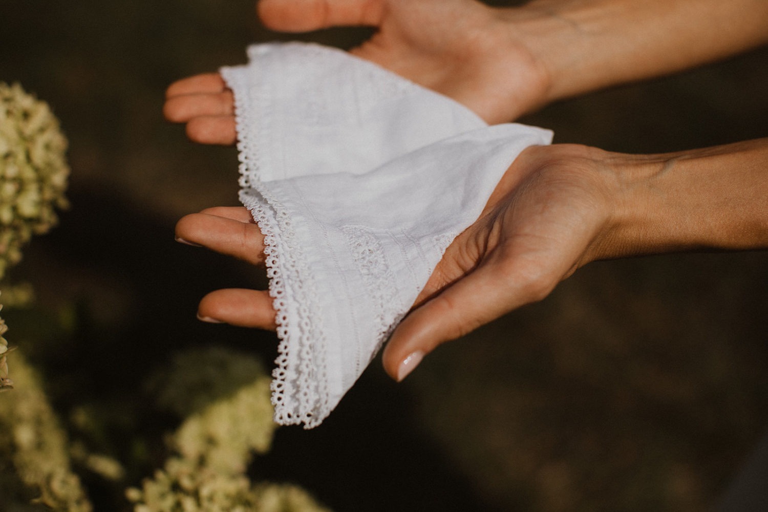 bride holds white handkerchief 