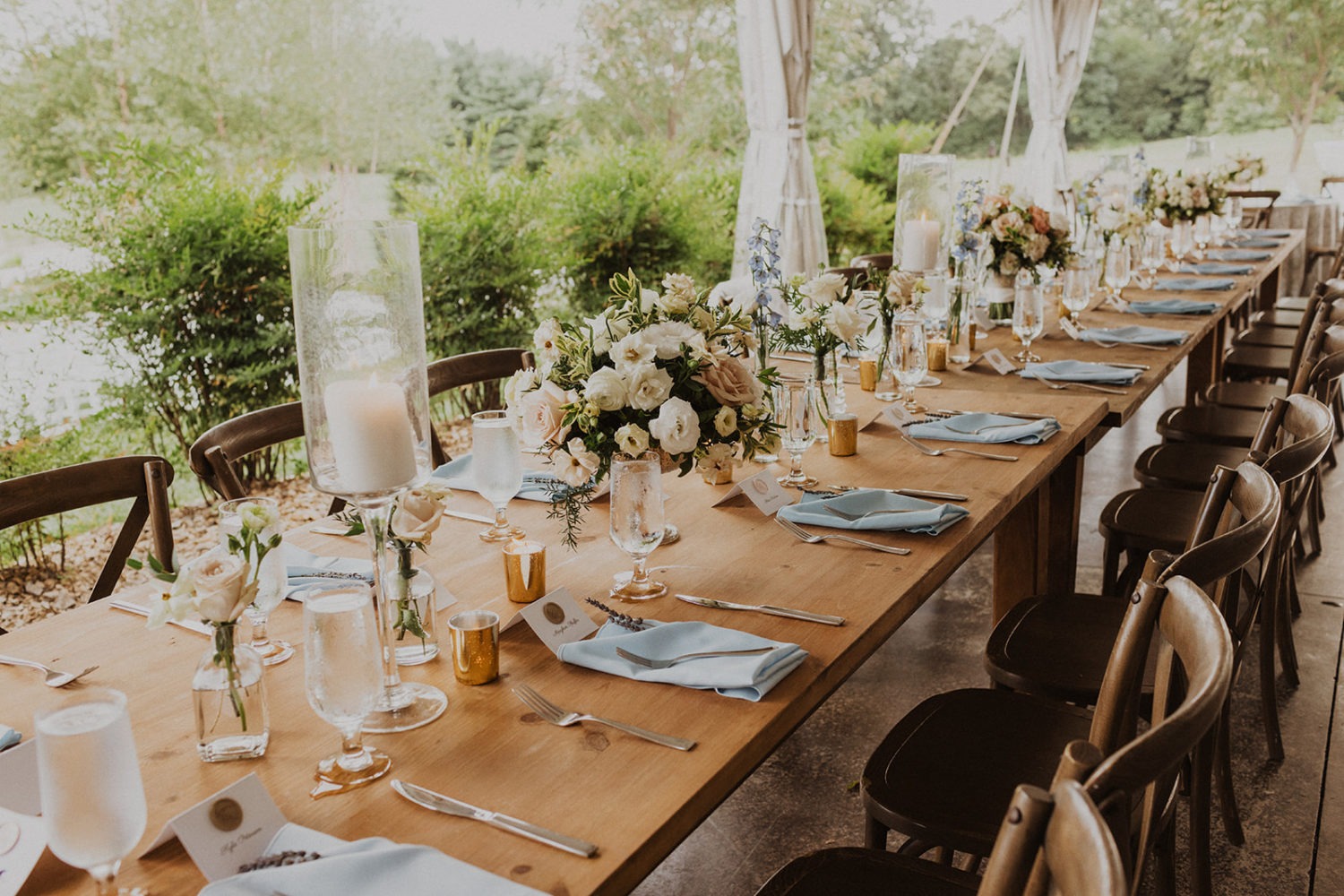 floral table settings at tented wedding reception