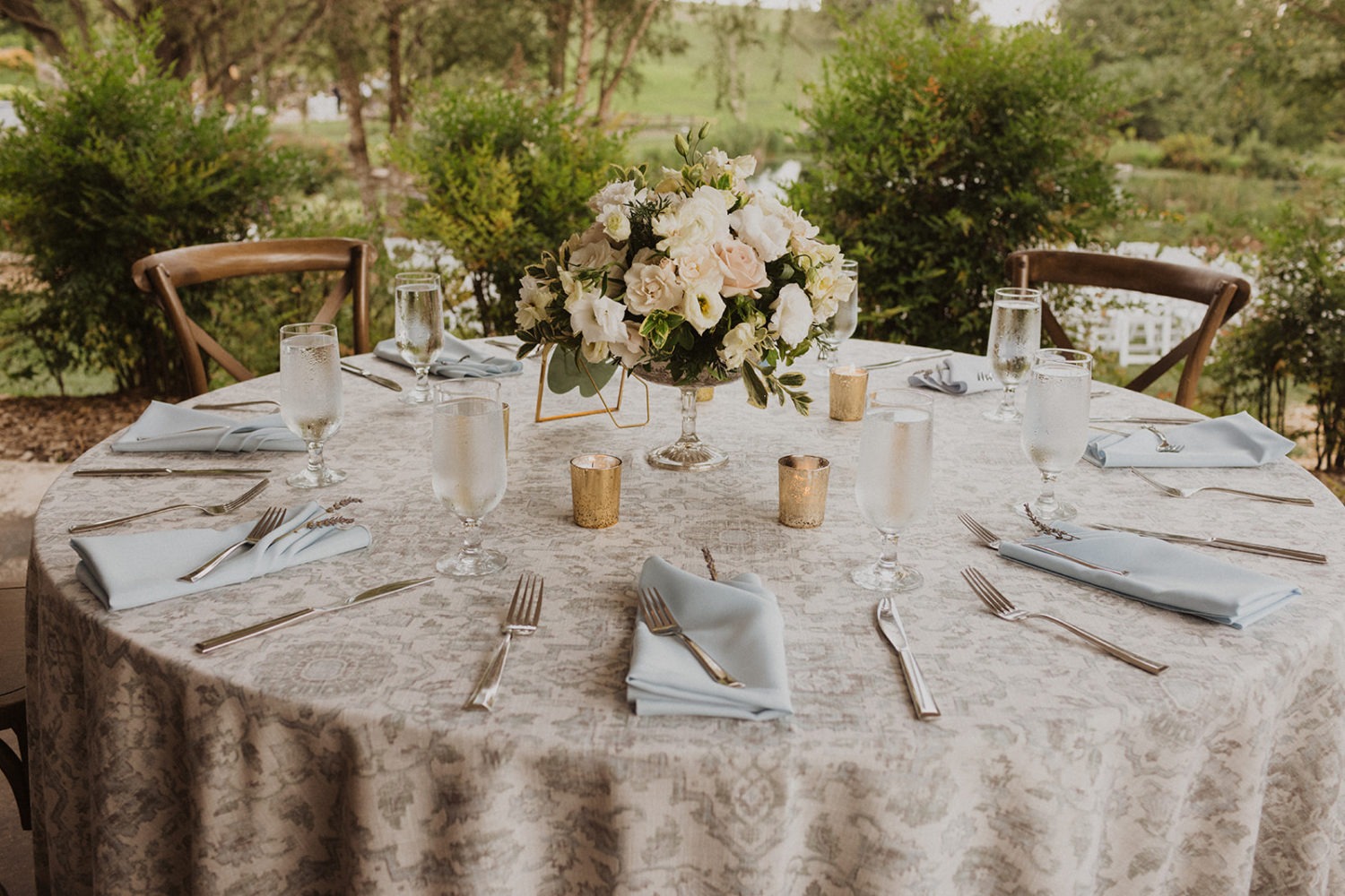 floral table settings at tented wedding reception