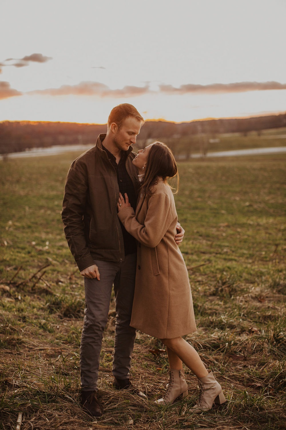 couple embraces at fall engagement photos session