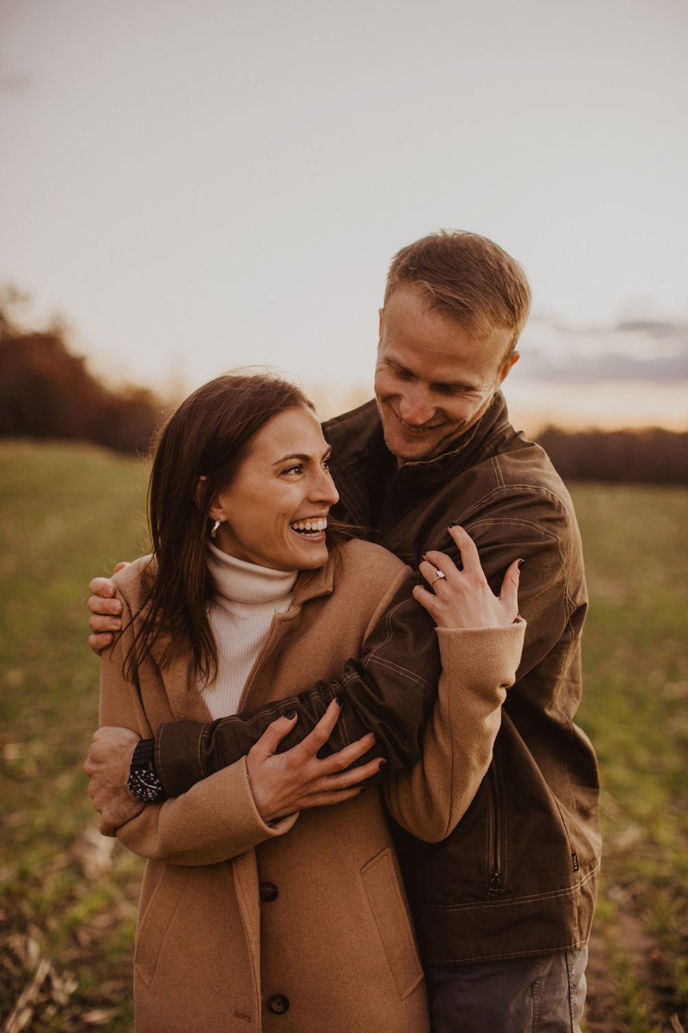 couple embraces at fall engagement photos session