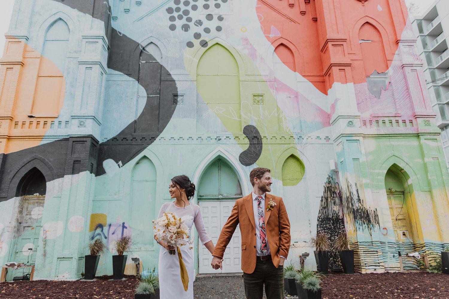 couple holds hands in front of Culture House DC wedding venue