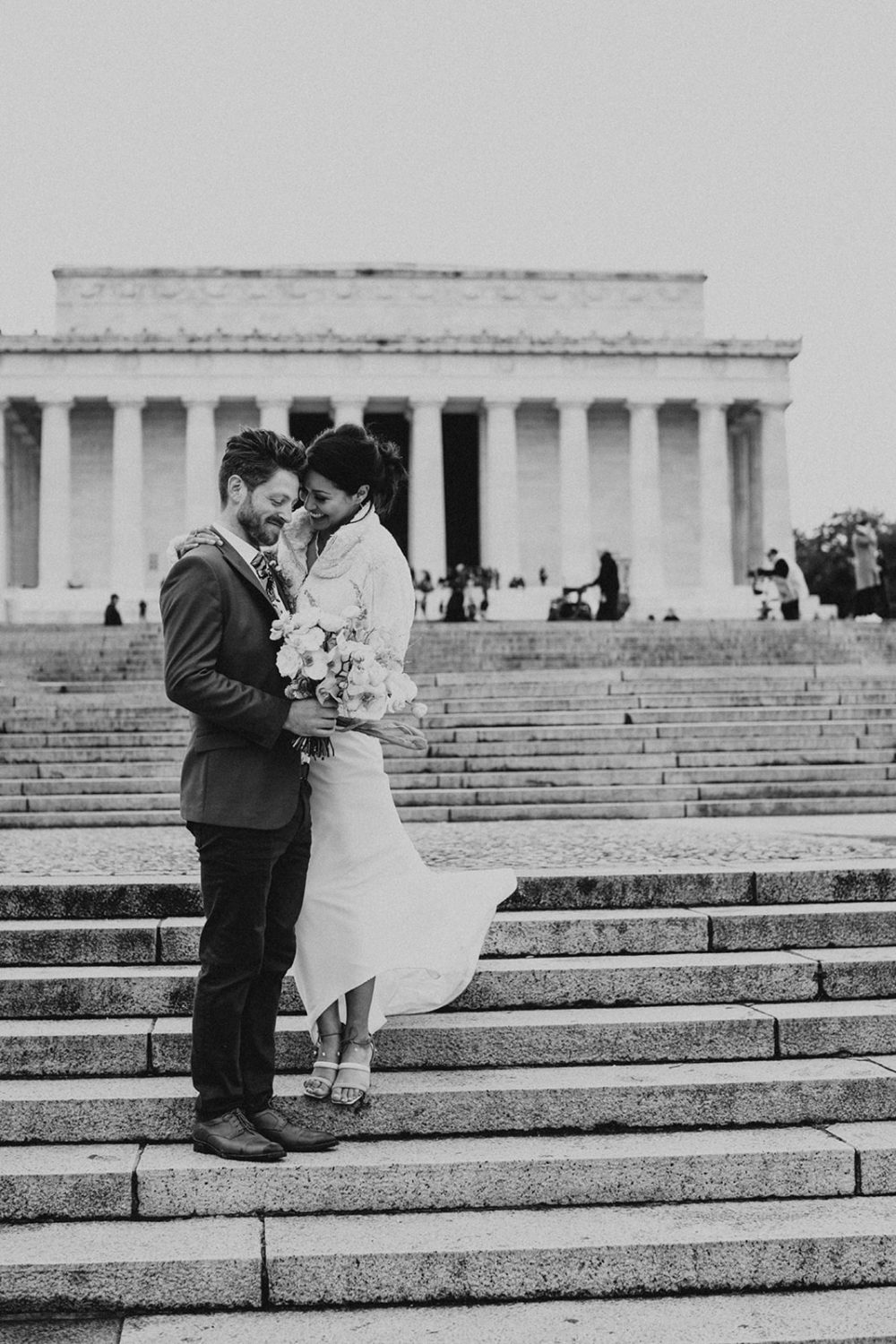 couple embraces on the steps of the DC Lincoln Memorial 