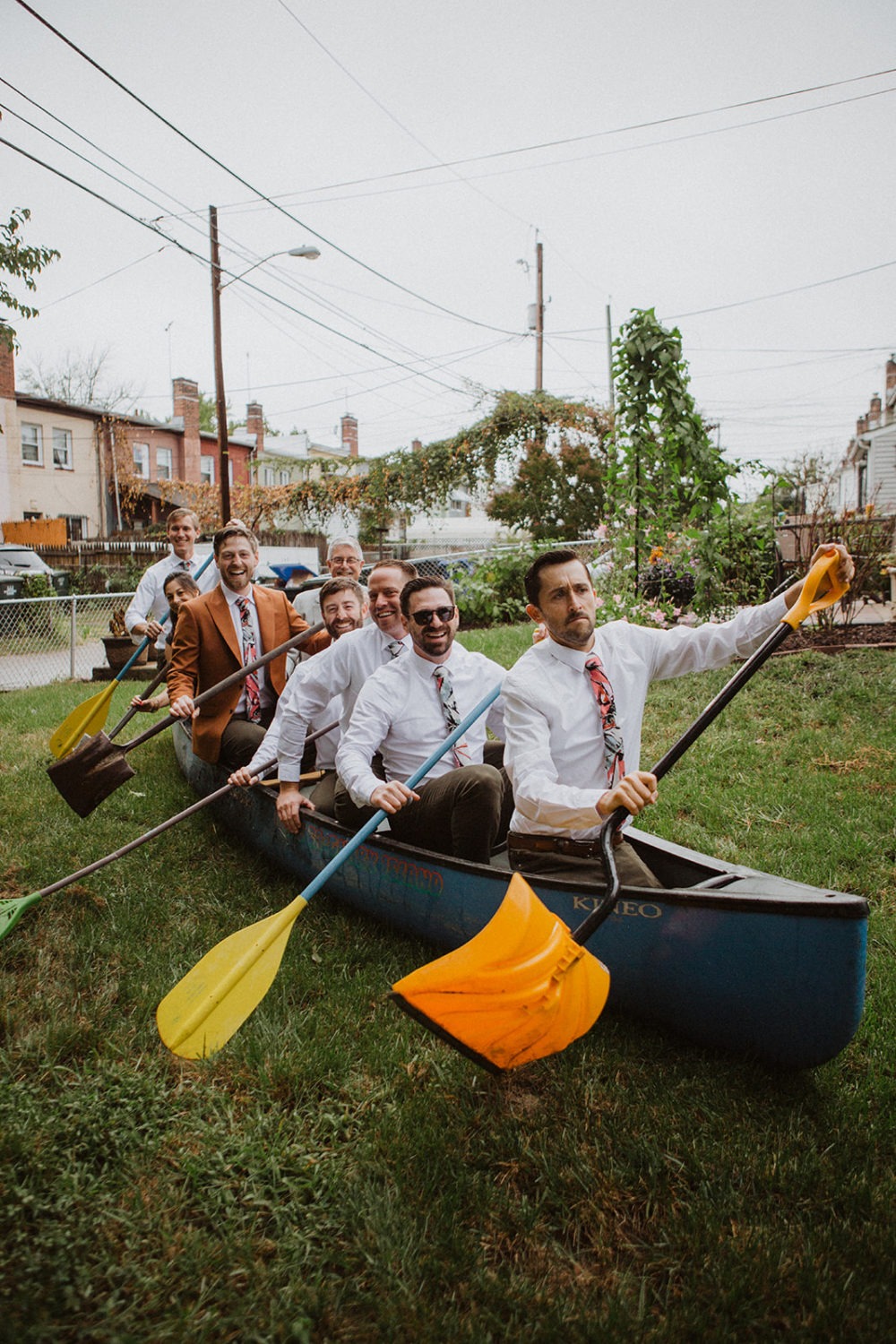 groomsmen row in canoe in backyard