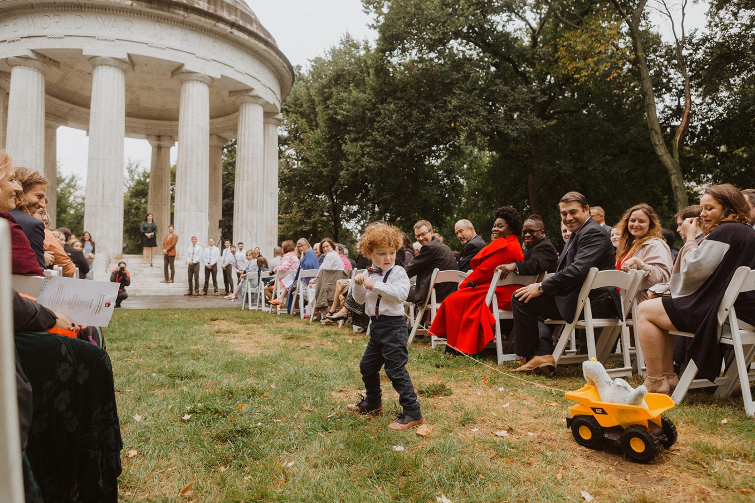 ring bearer pulls rings in toy truck at DC War Memorial wedding