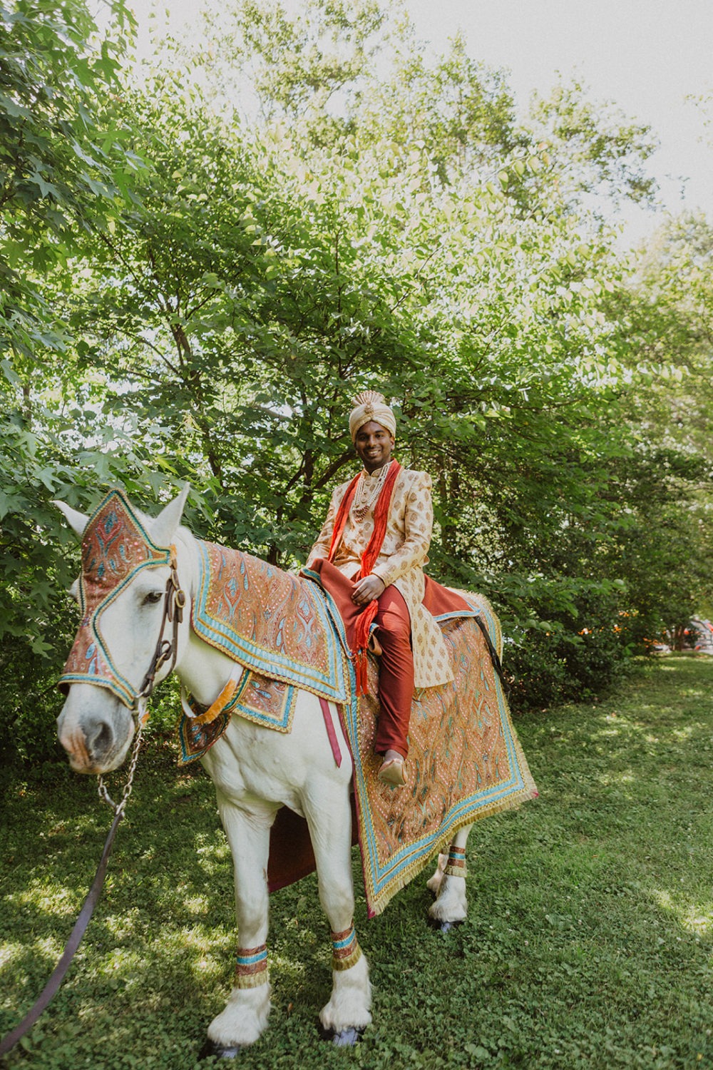 groom rides on horse as part of hindu wedding traditions