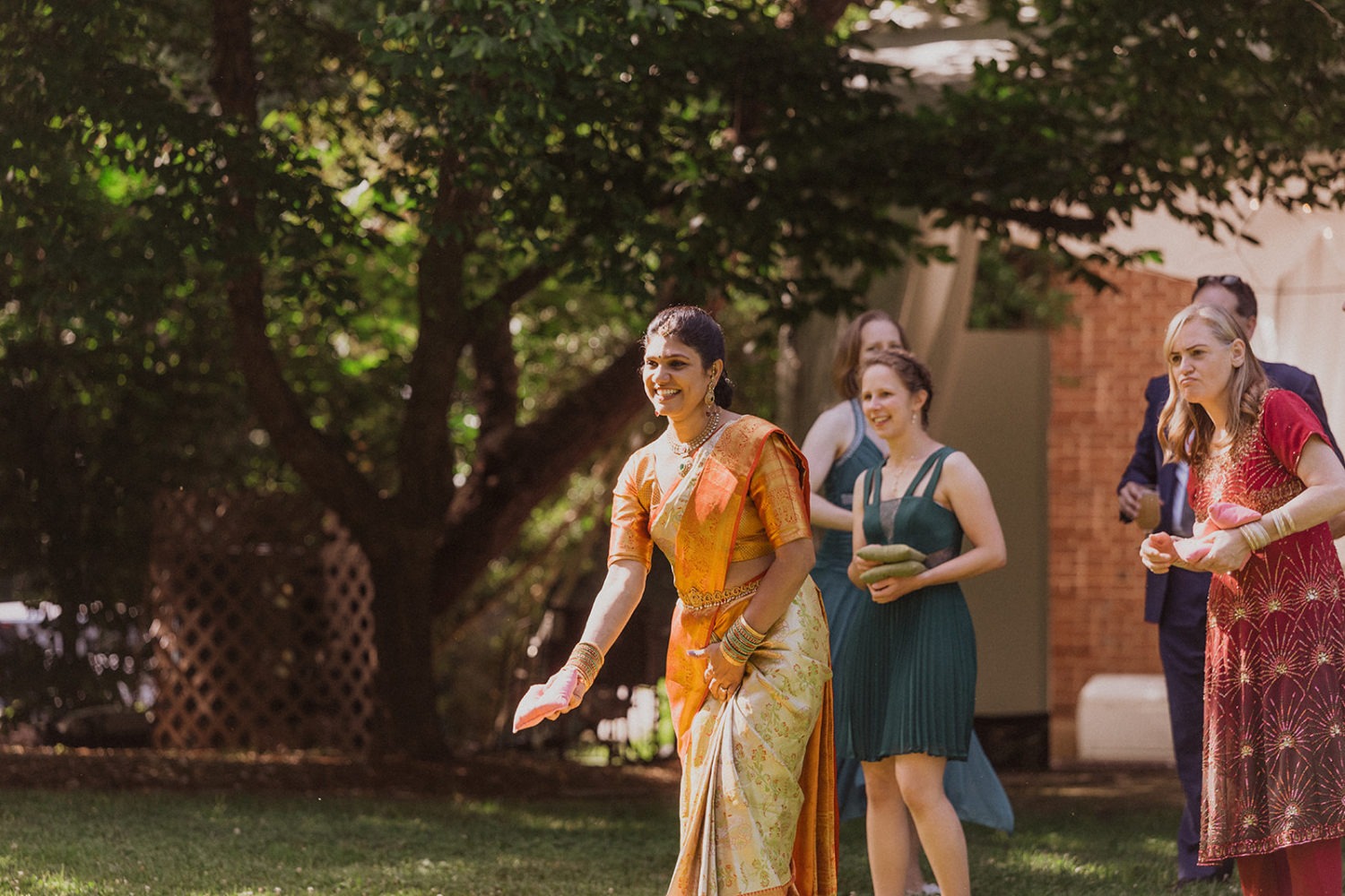 woman in indian clothing plays lawn game at outdoor maryland wedding