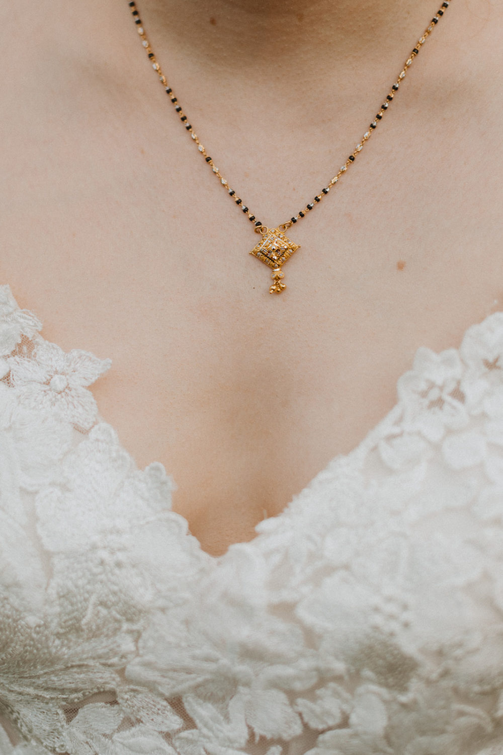 bride wears gifted wedding necklace as part of hindu wedding traditions