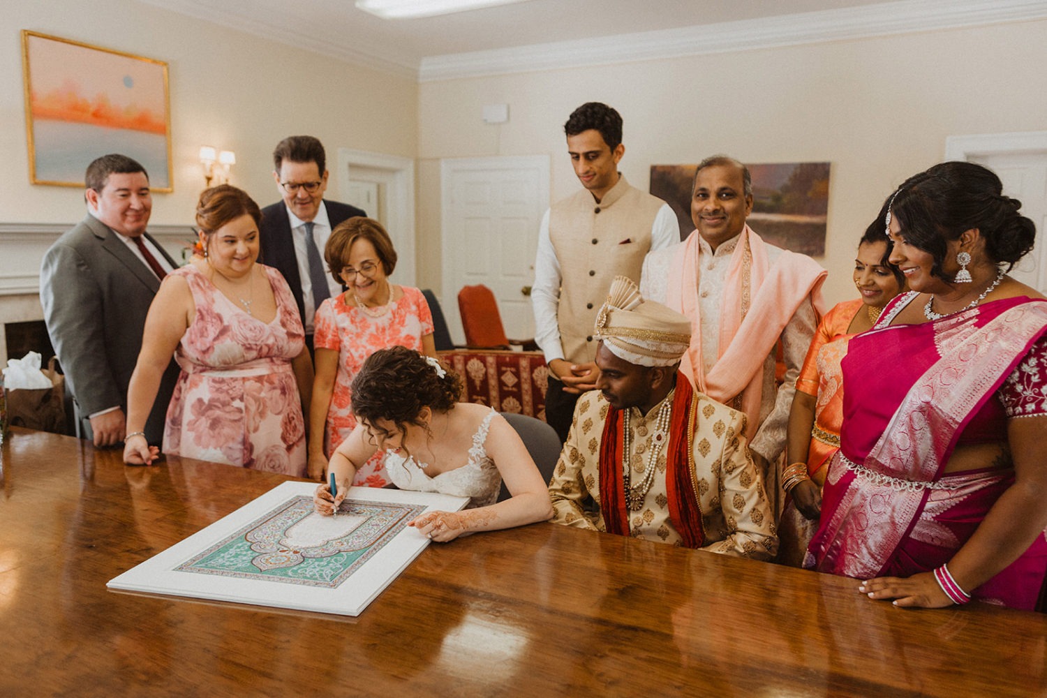 couple signs document as part of jewish wedding traditions
