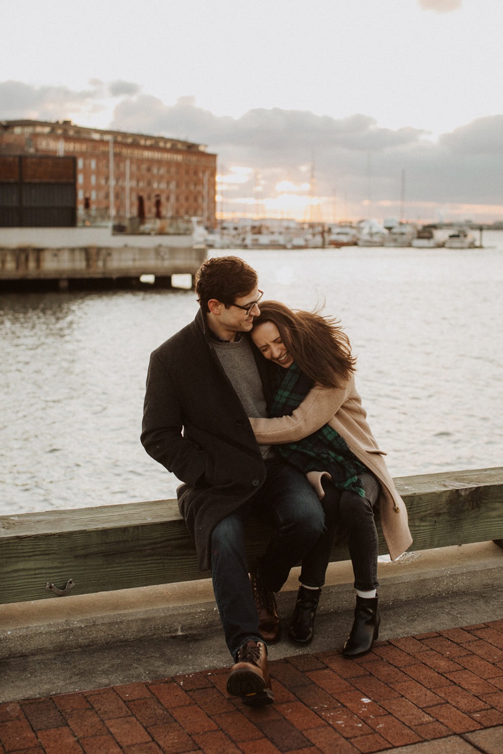 couple embraces at Baltimore windy engagement session