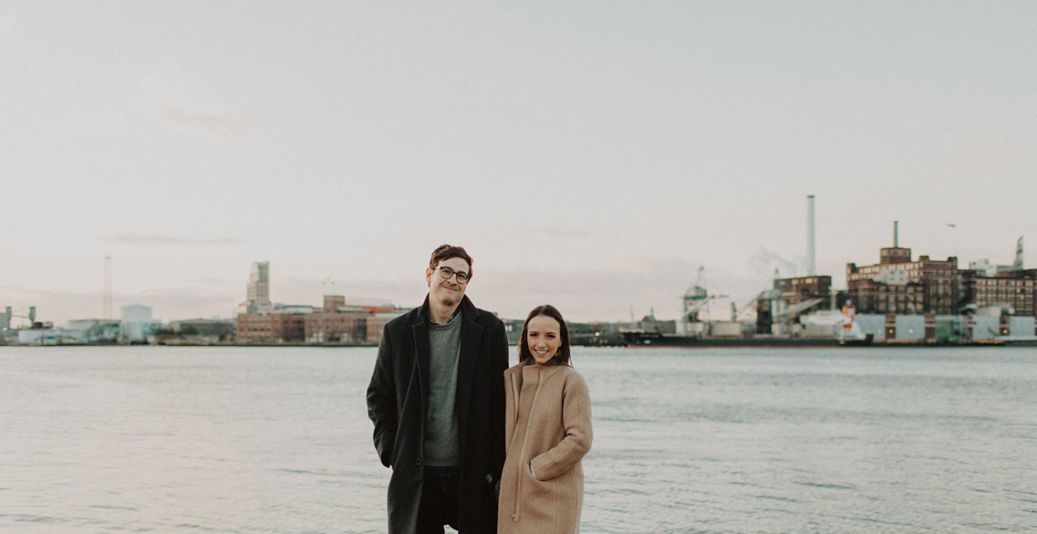 couple holds hands at Baltimore engagement photos in winter