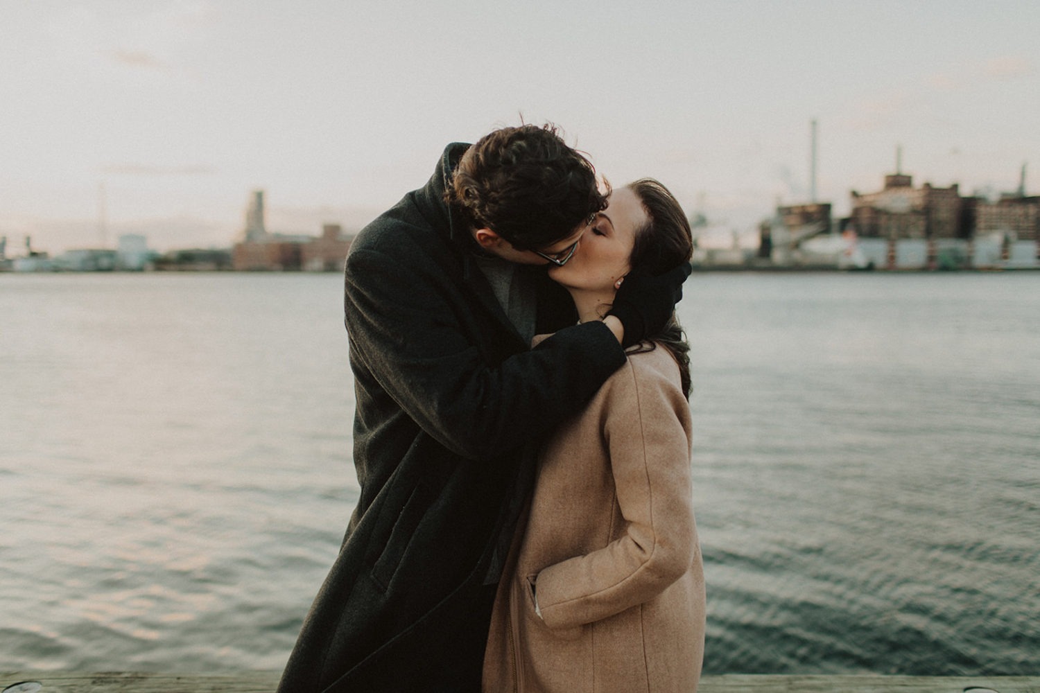couple kisses at Baltimore engagement photos in winter