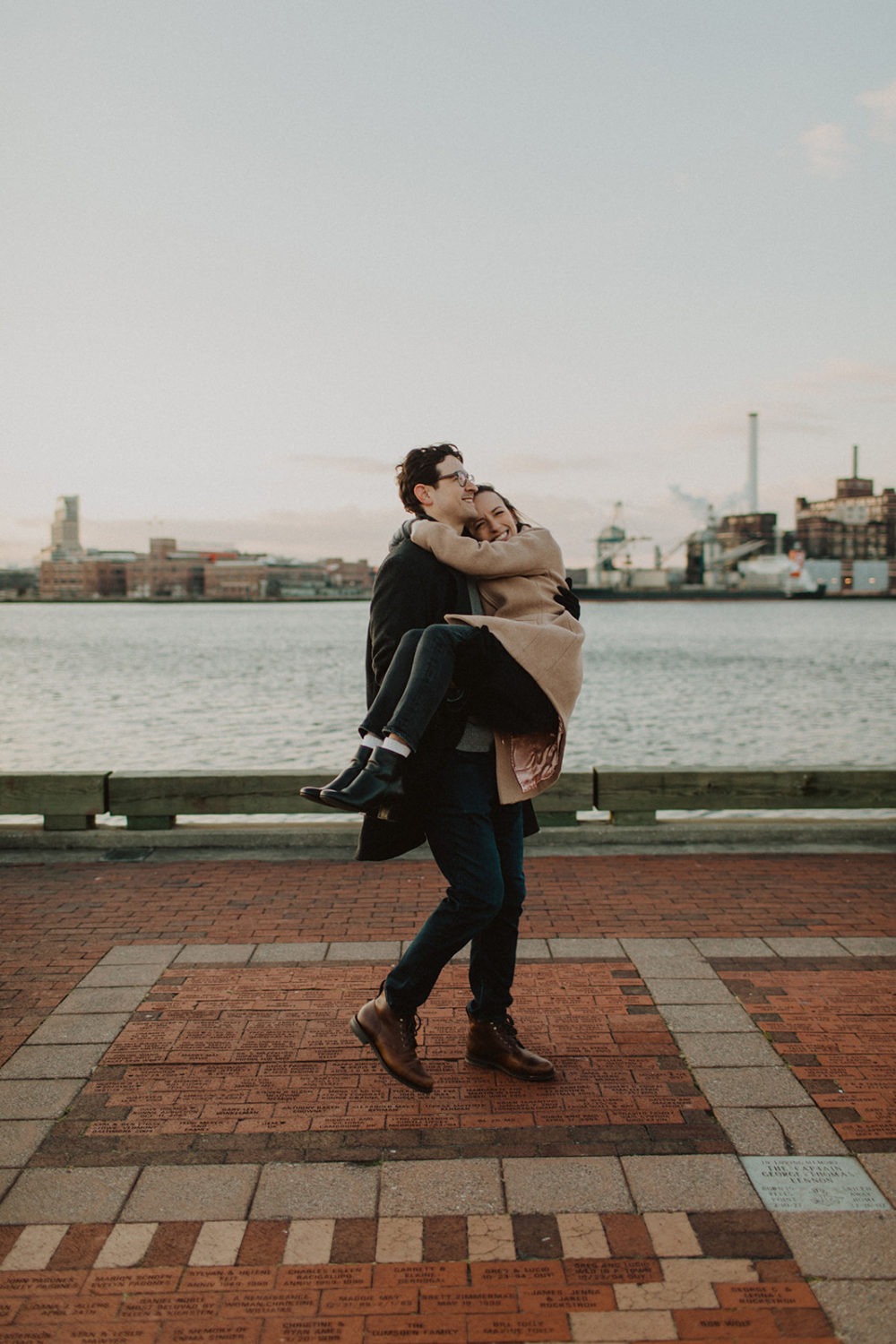 couple embraces at engagement photos in winter
