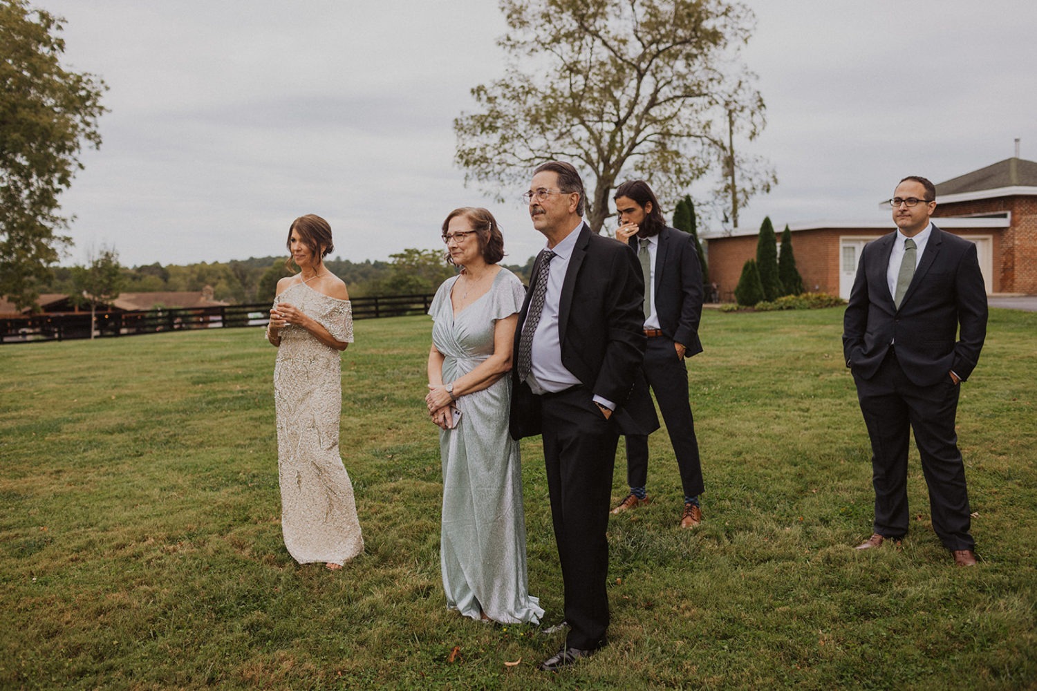 family watches bride and groom exchange vows during wedding first look