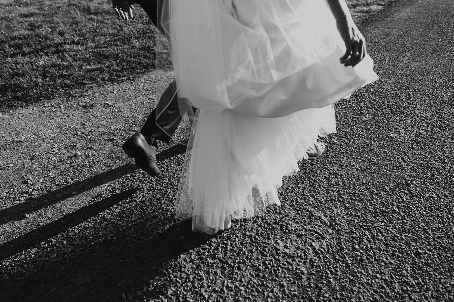 couple walks on gravel road at virginia wedding venue