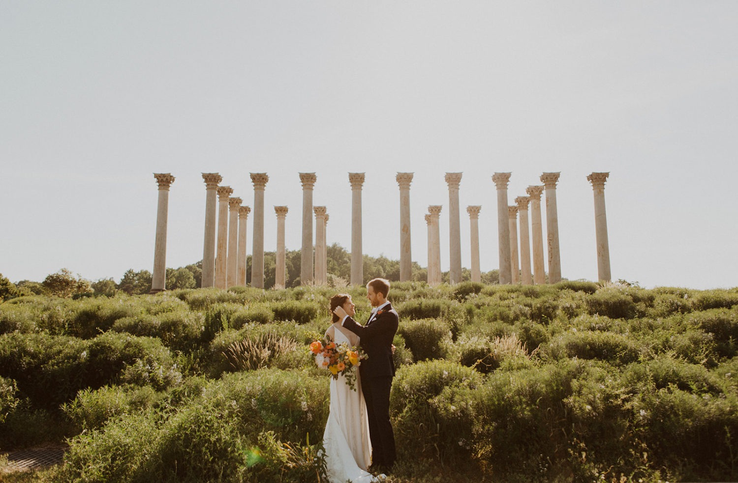 Newlyweds stand together in front of Capitol Columns at National Arboretum DC wedding