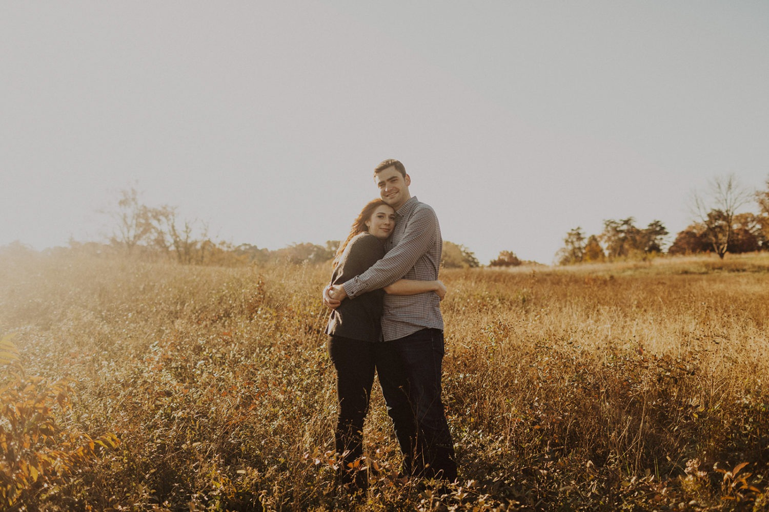 Couple embraces in field at National Arboretum DC engagement session
