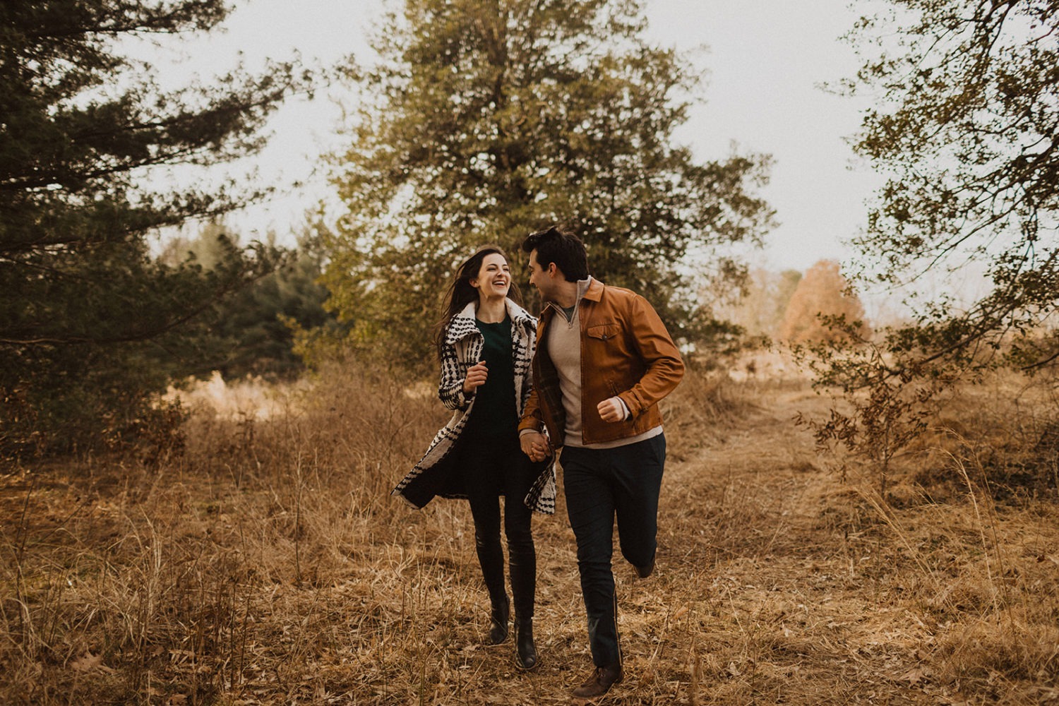 couple runs through woods at National Arboretum DC engagement session