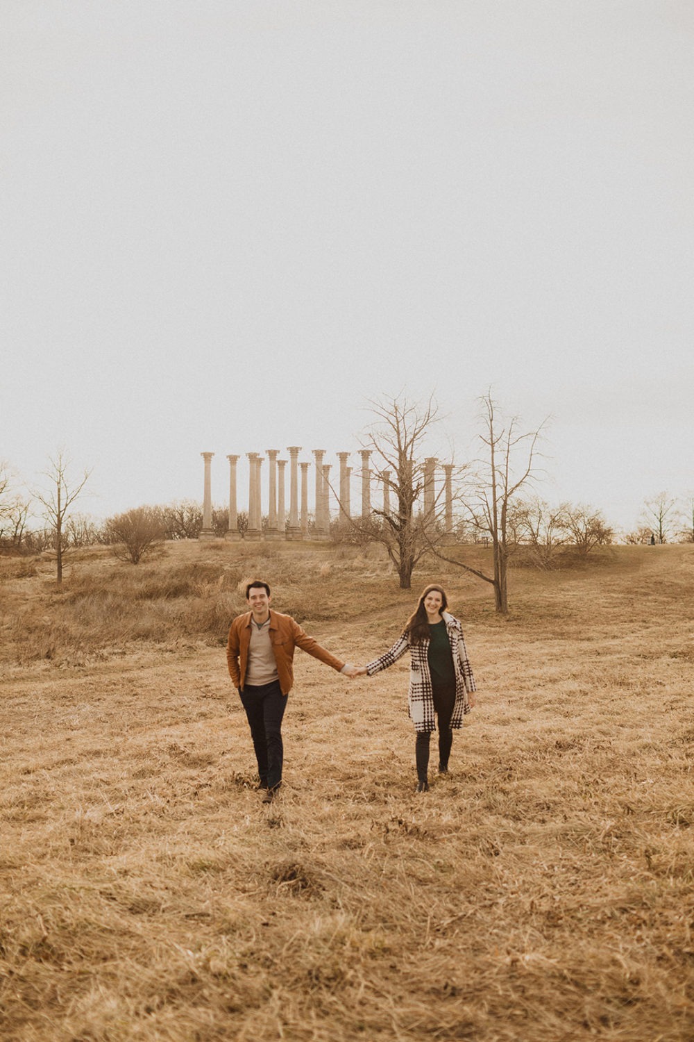 couple runs through field at at National Arboretum DC engagement session