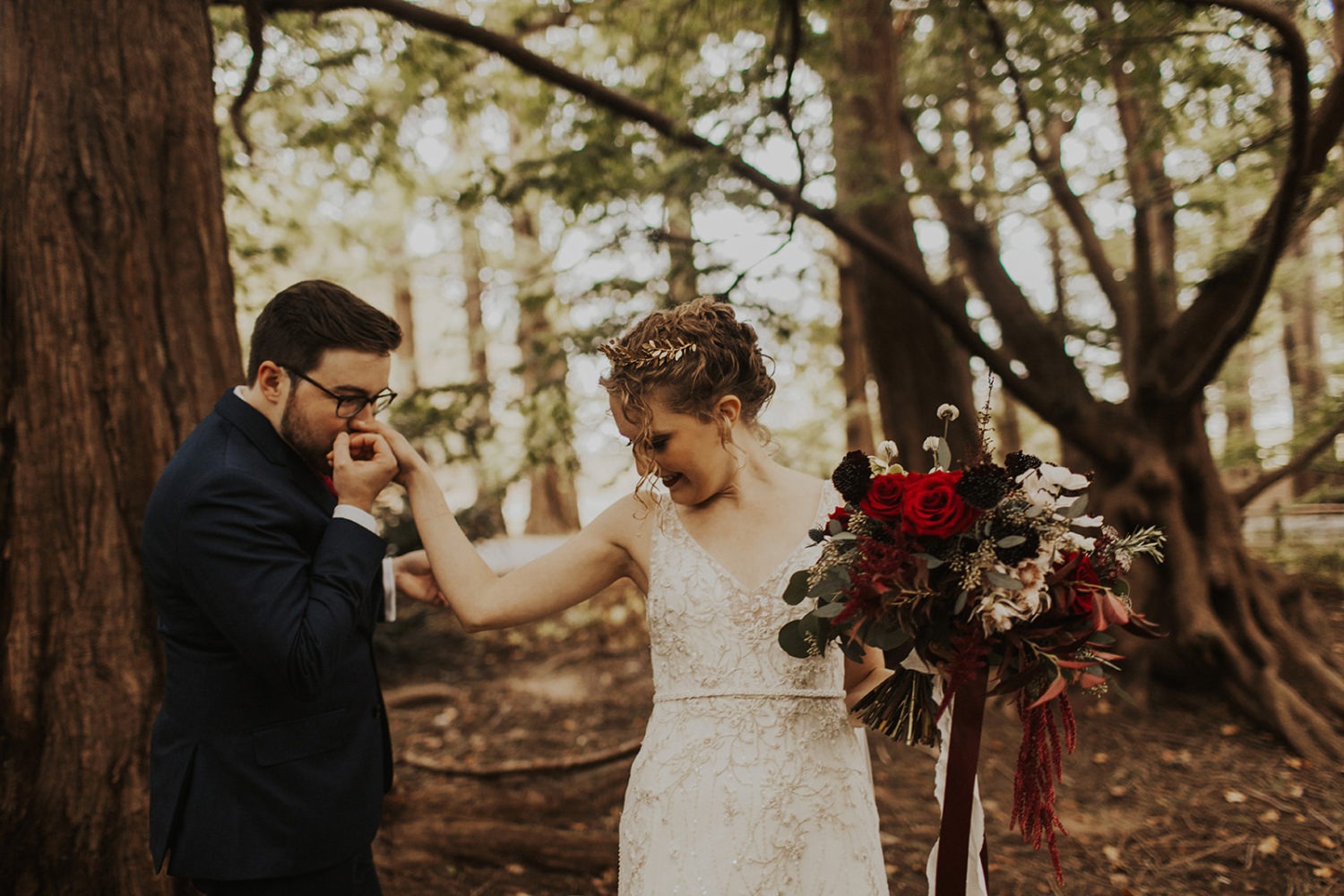 couple walks through woods at wedding first look