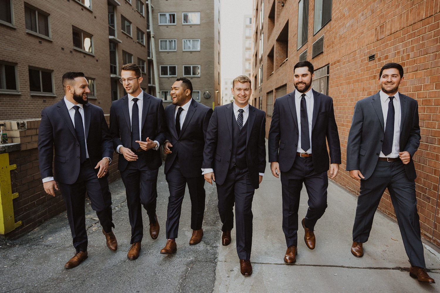 groomsmen stand in DC alleyway at mansion wedding venue