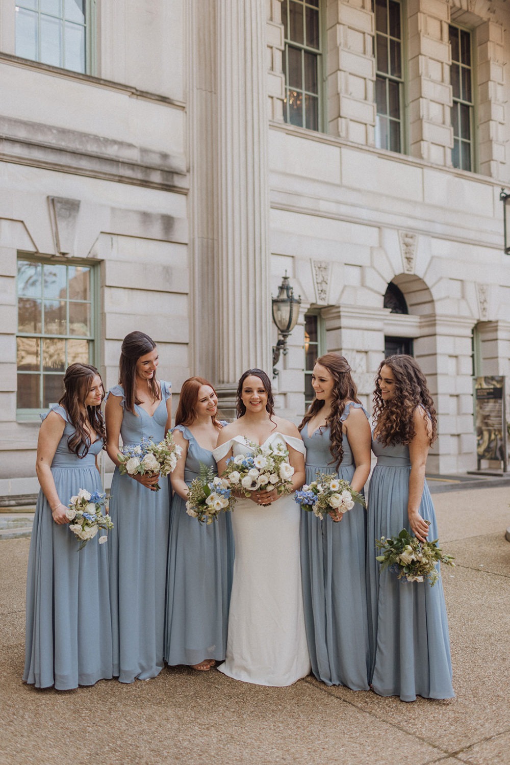 bridesmaids stand under columns at DC estate