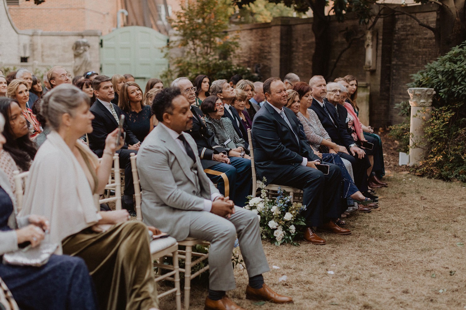 weddings guests sit during outdoor DC garden wedding ceremony