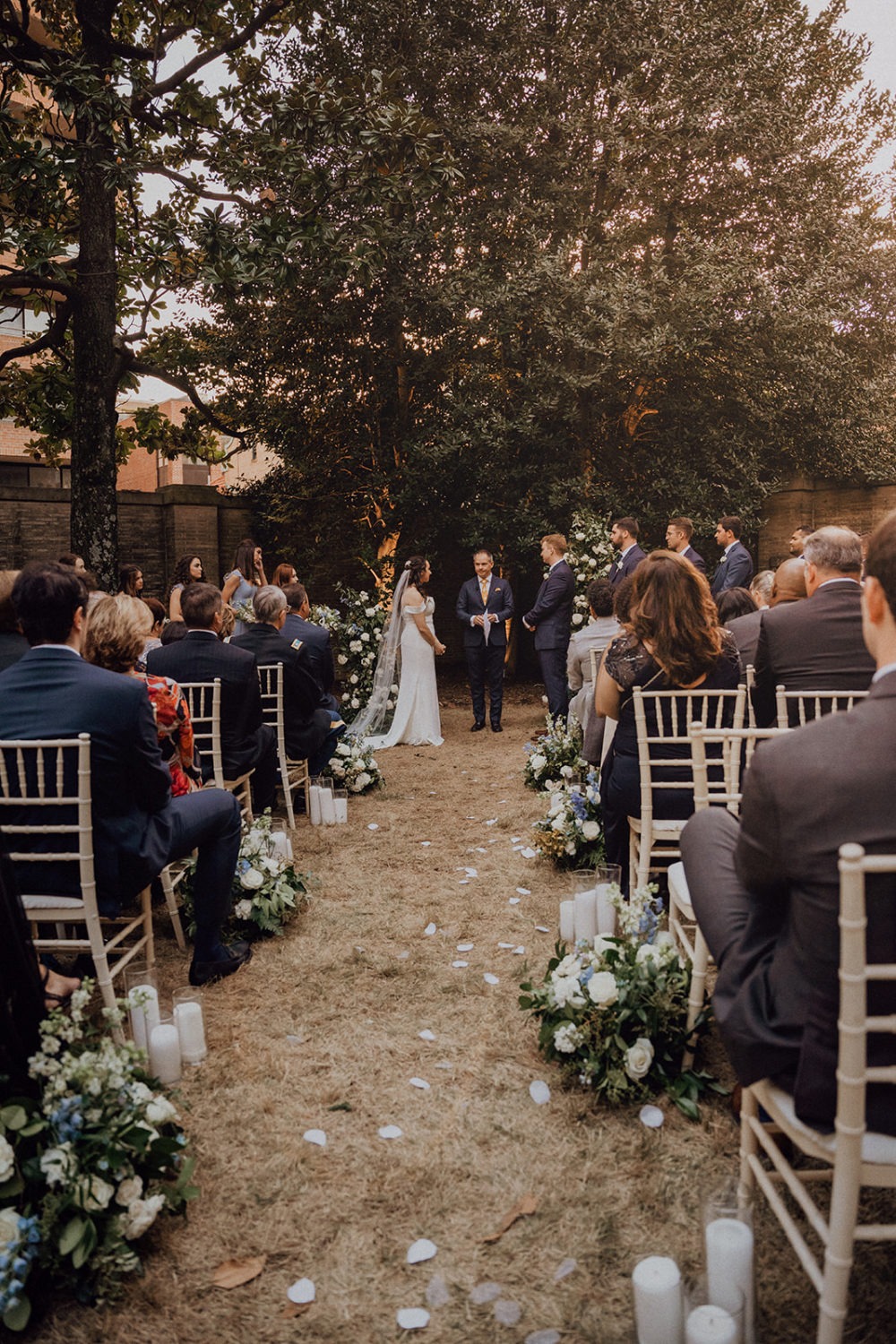 couple exchanges vows during outdoor garden wedding ceremony