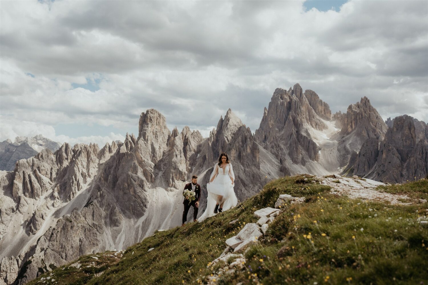 couple climbs to mountaintop at Italy elopement