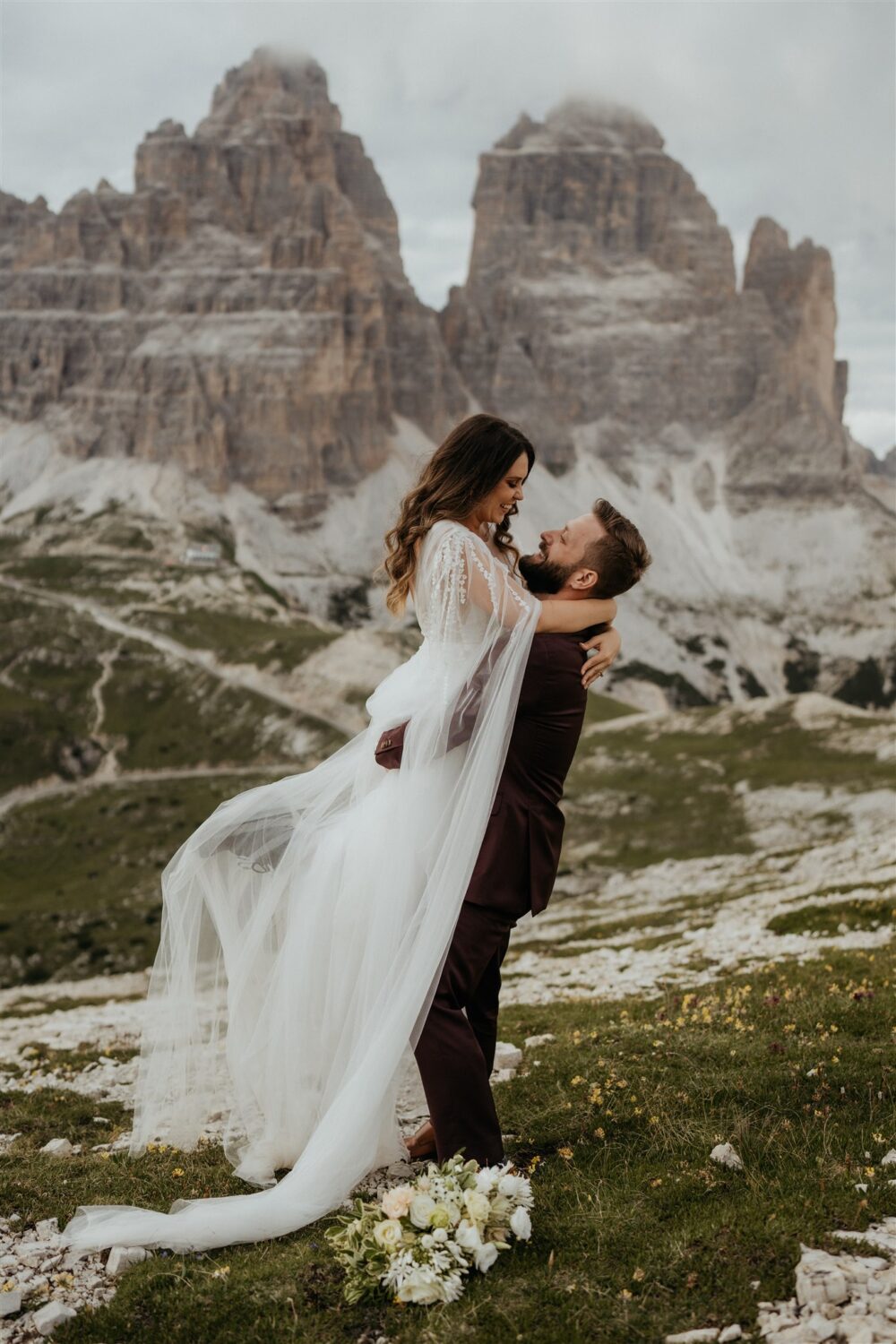 groom lifts bride at Italian Dolomites elopement