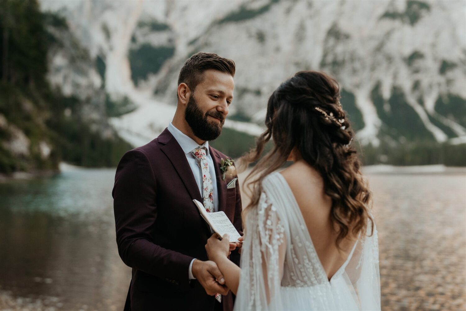 couple exchanges vows beside mountainside lake at the Dolomites