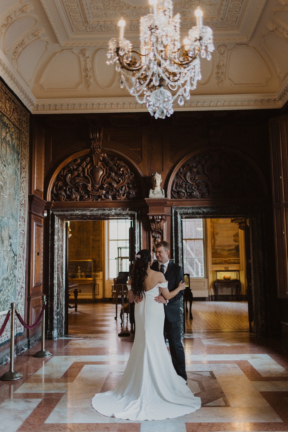 couple stands embracing in hallways at DC estate