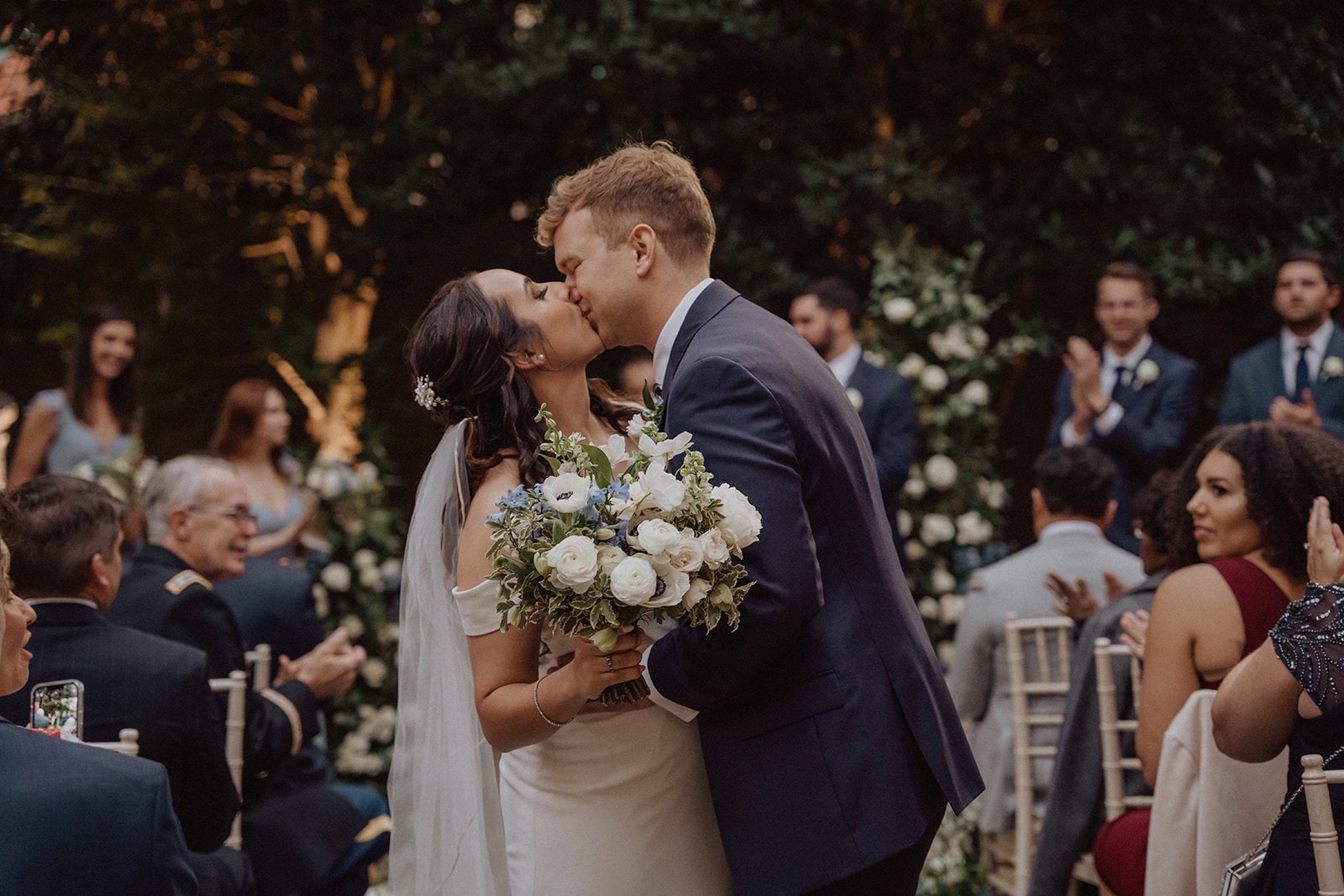 couple kisses during DC garden wedding exit