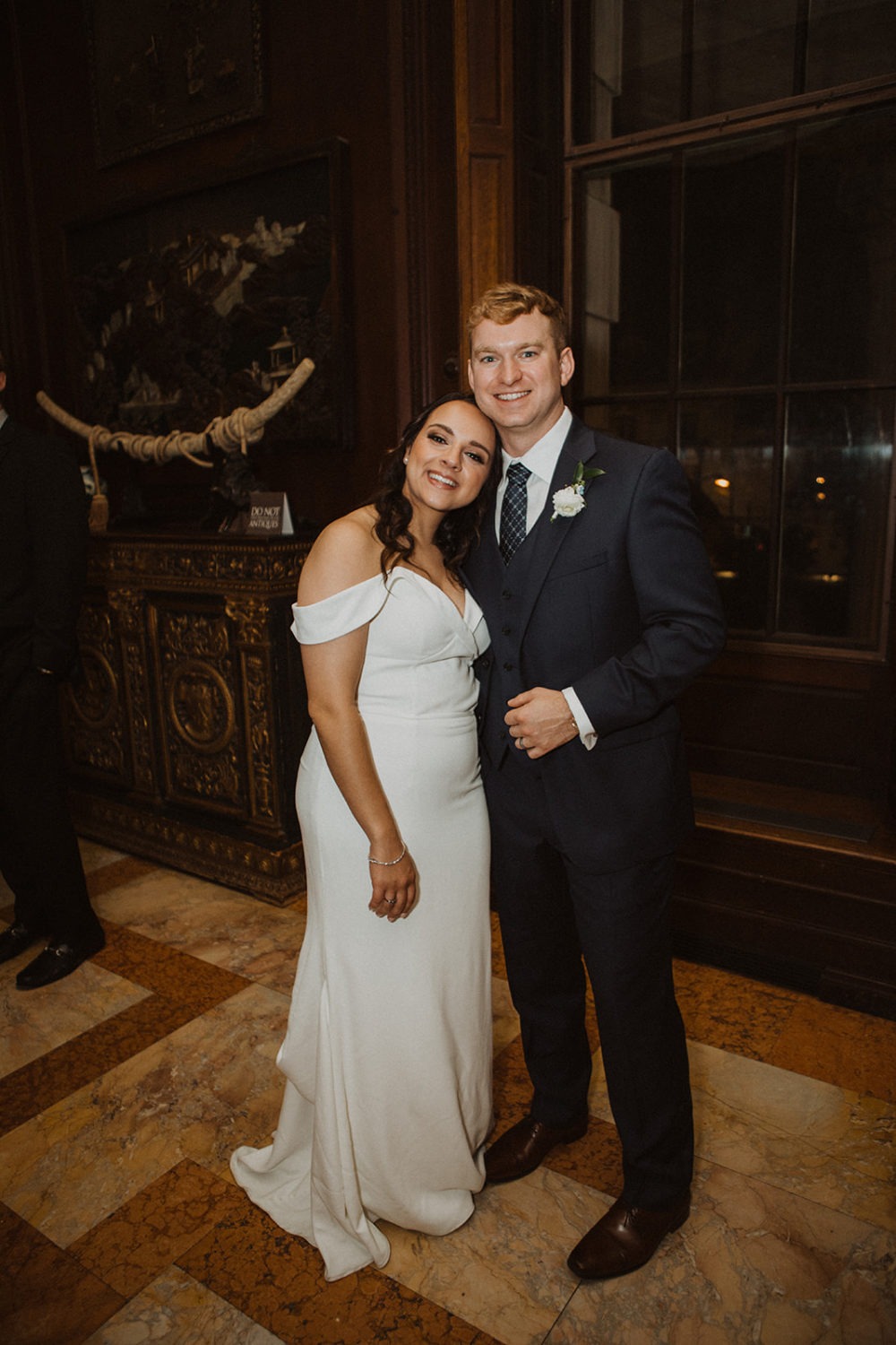 couple embraces in hallway at mansion wedding venue
