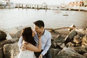 couple kisses beside Old Town Alexandria waterfront