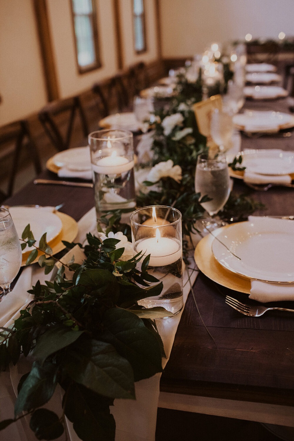gold and white table setting decor at barn wedding