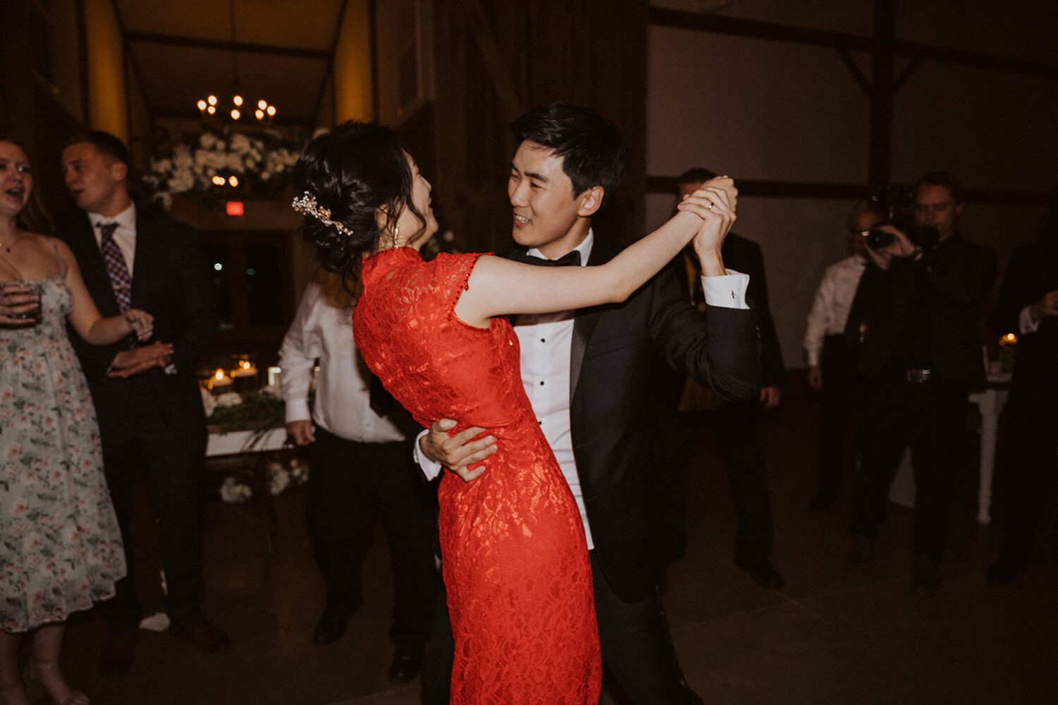 couple dances together on dance floor at wedding reception