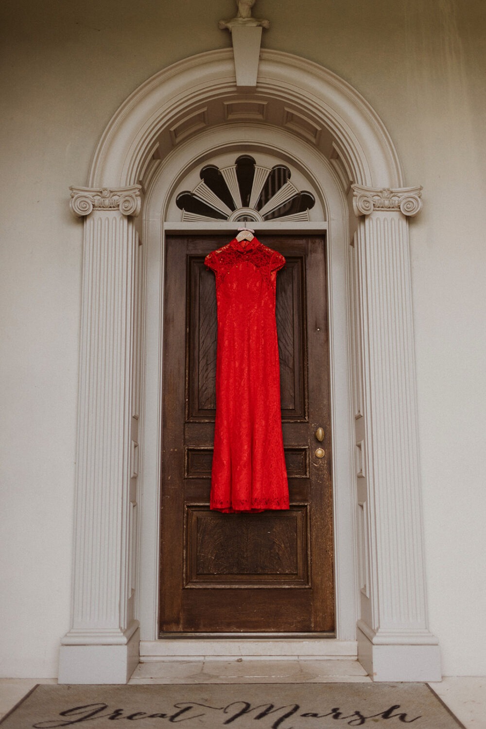 red traditional Chines wedding dress hangs on doorway