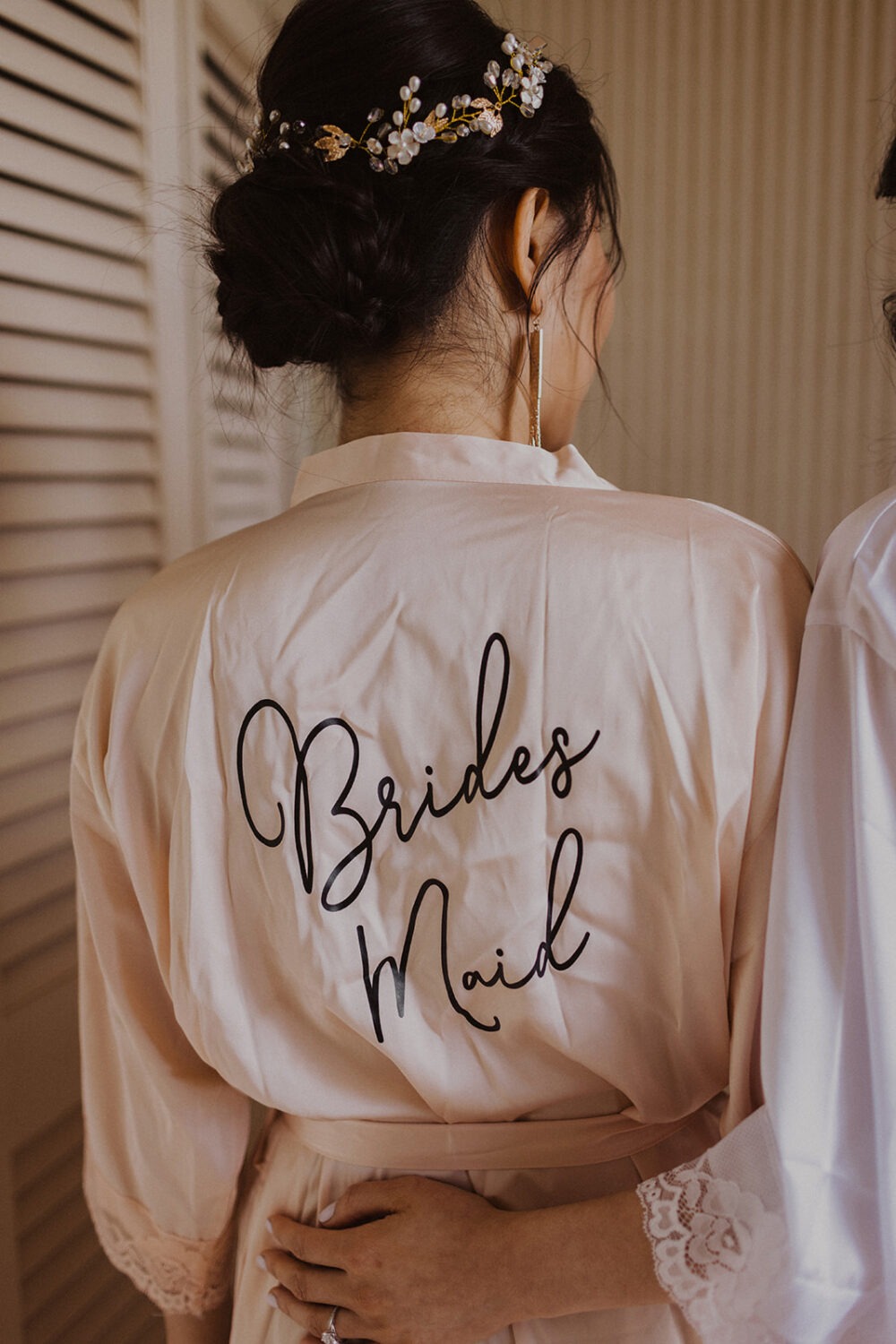 bridesmaid wears monogrammed silk robe