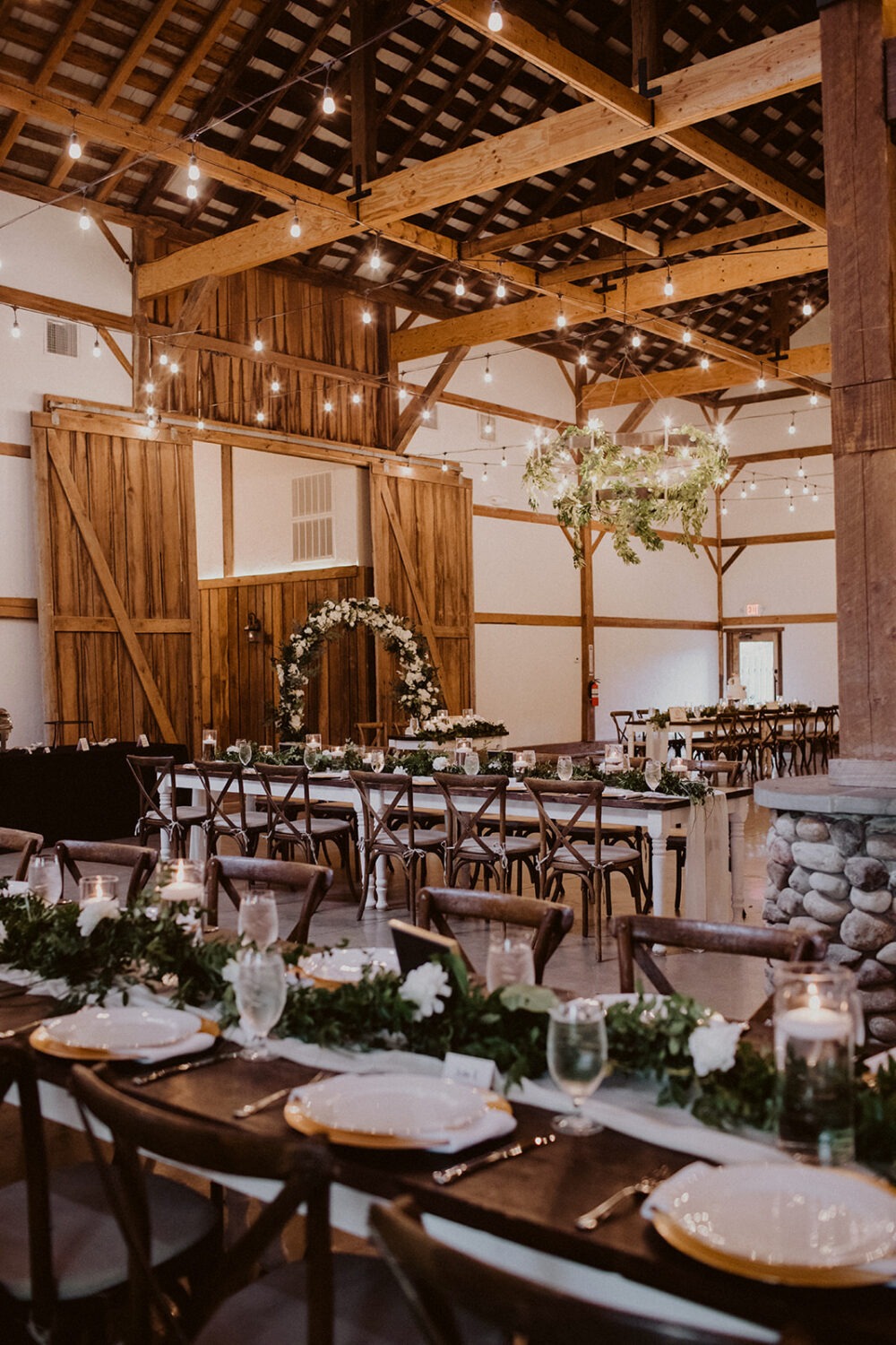 gold and white table setting decor at barn wedding