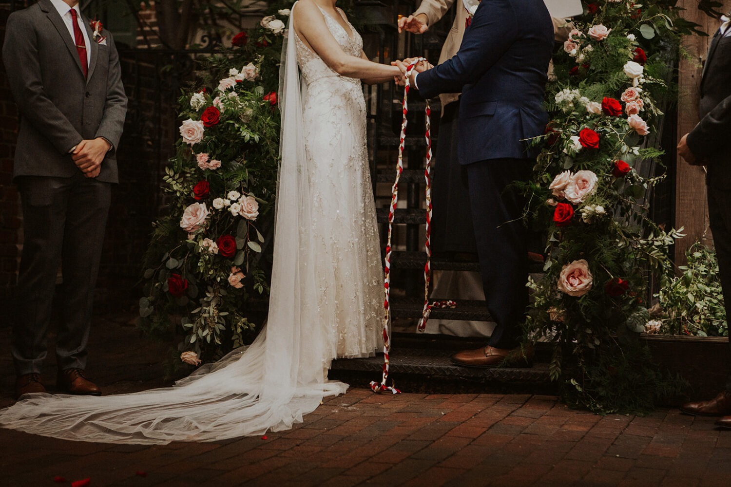 couple exchanges vows with wedding rope during ceremony 