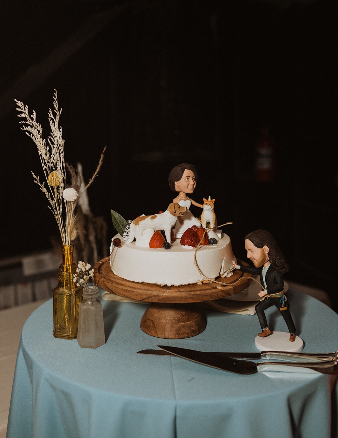 wedding topper with bride and groom climbing cake 