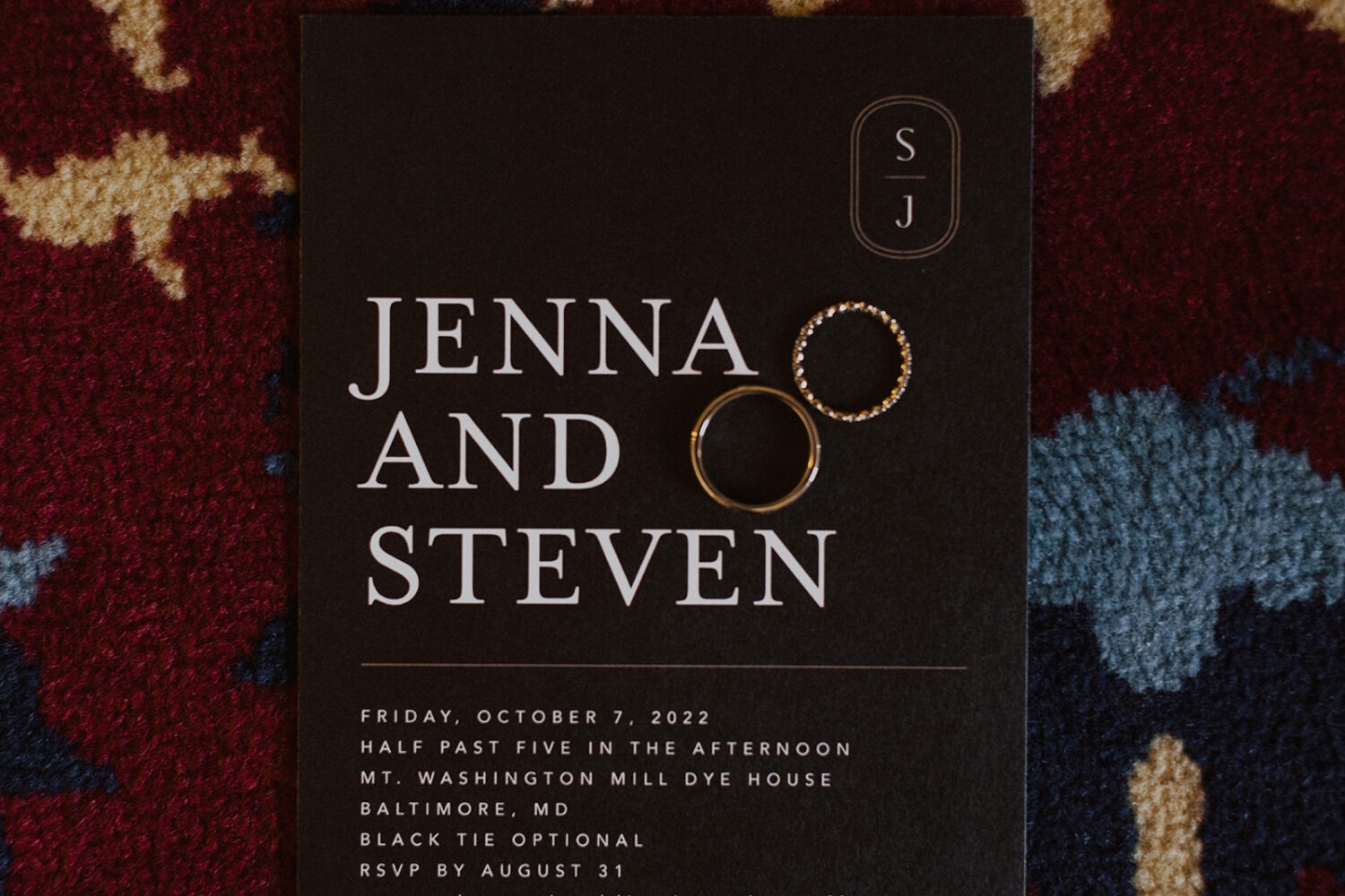 black and white wedding invitation with gold rings
