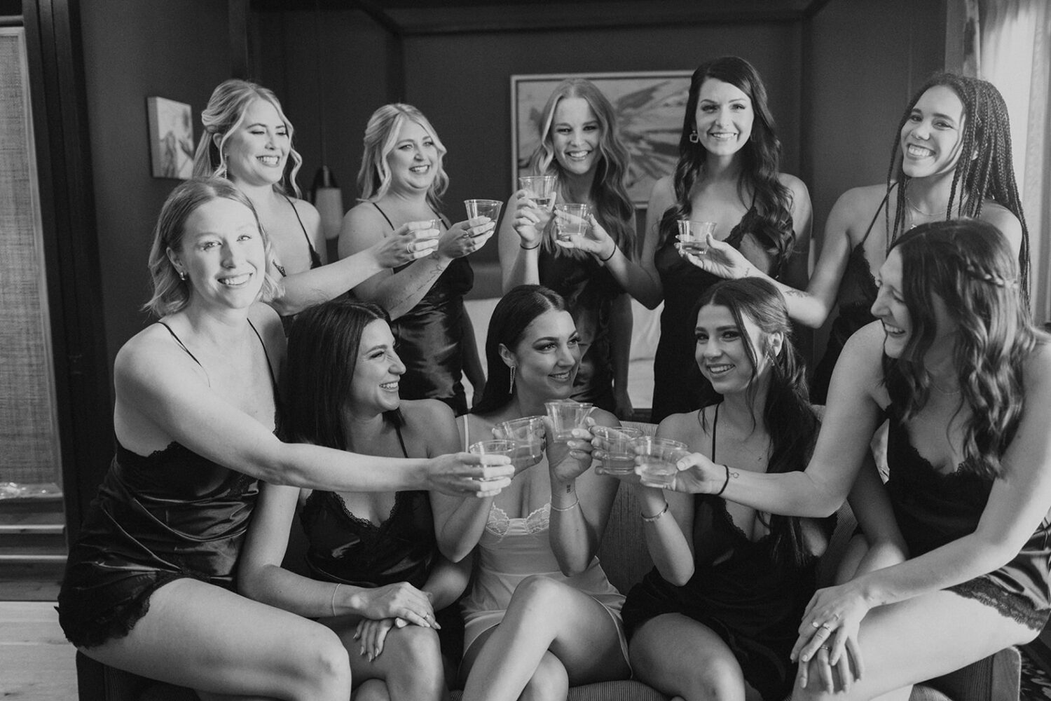 bridesmaids cheers with bridesmaid in silk slips at hotel