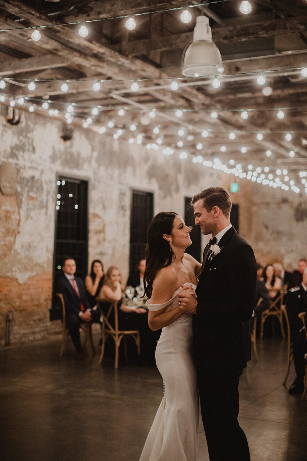 couple dances under twinkle lights at Mt. Washington Mill Dye House wedding venue