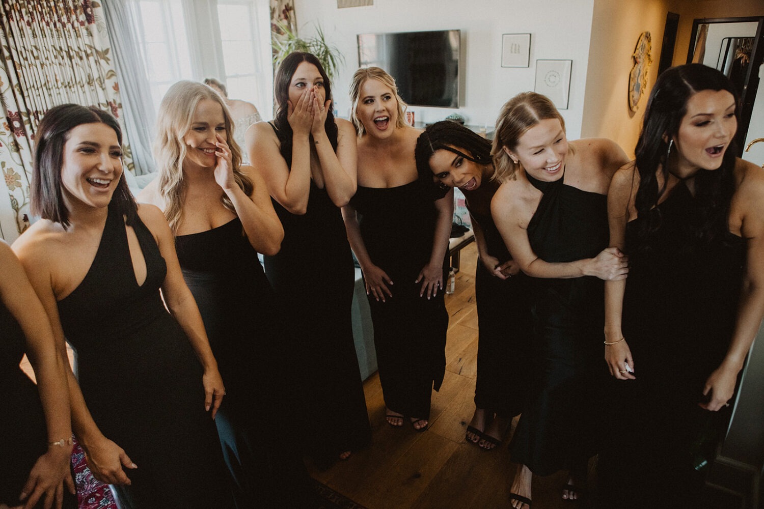 bridesmaids react during bride first look at hotel
