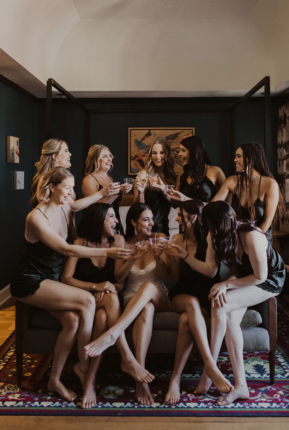 bridesmaids cheers with bridesmaid in silk slips at hotel
