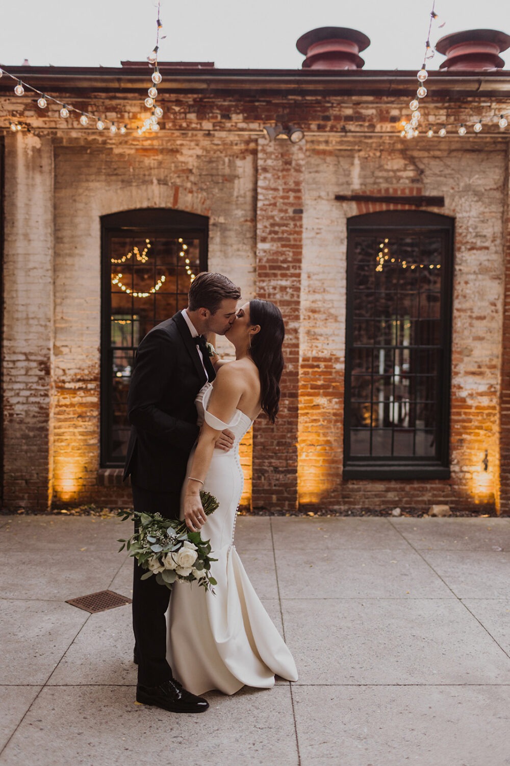 couple kisses at Mt. Washington Mill Dye House wedding venue