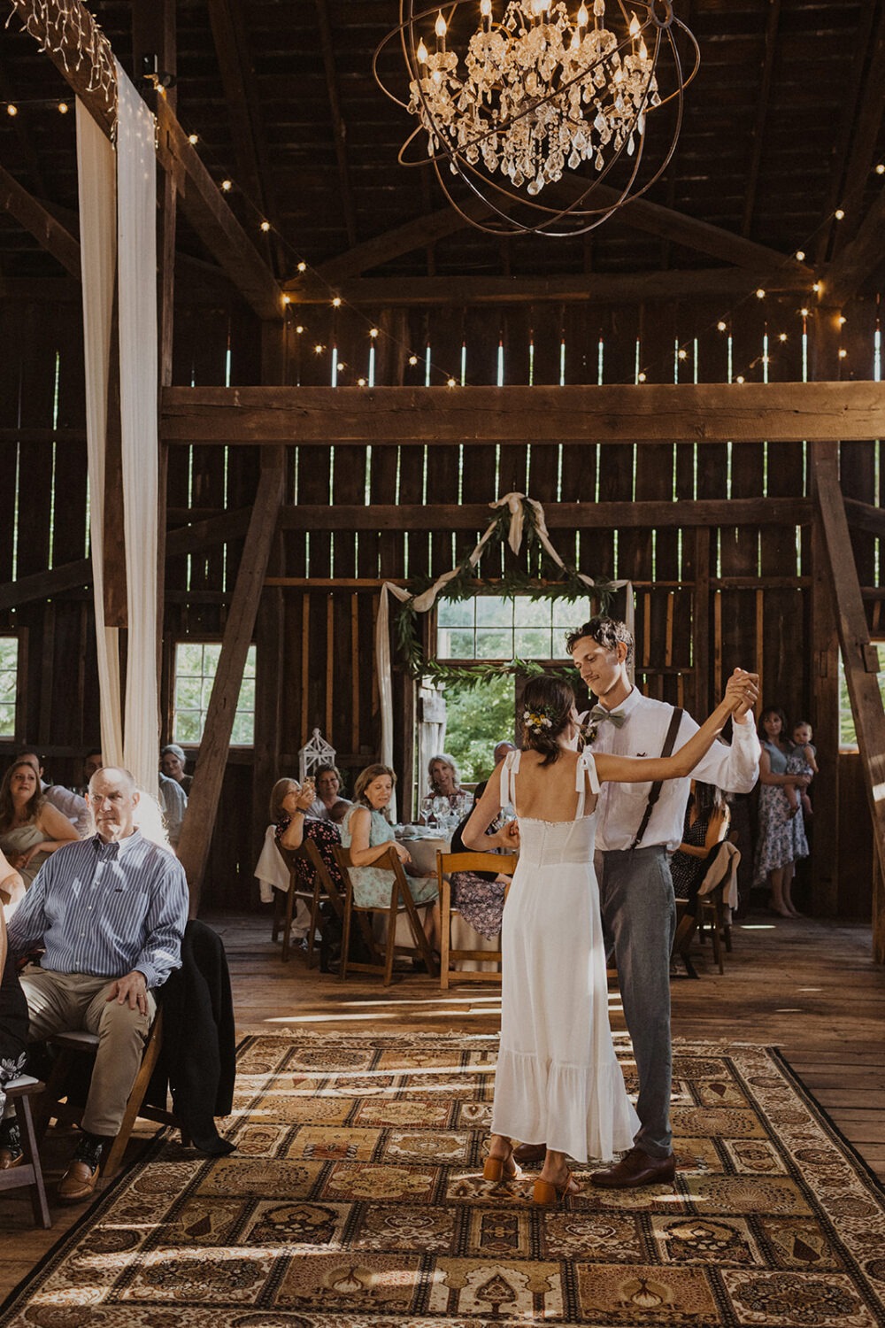 couple dances in barn at rustic barn wedding 